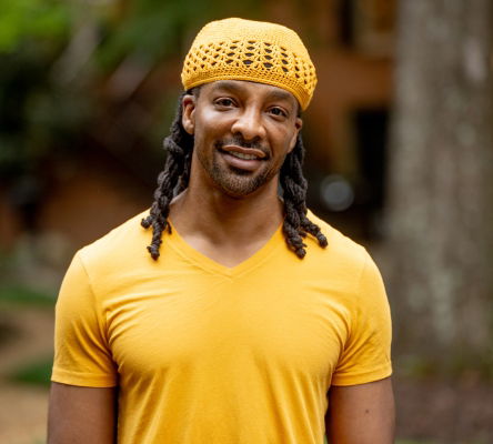 Jericho Brown in yellow shirt and hat